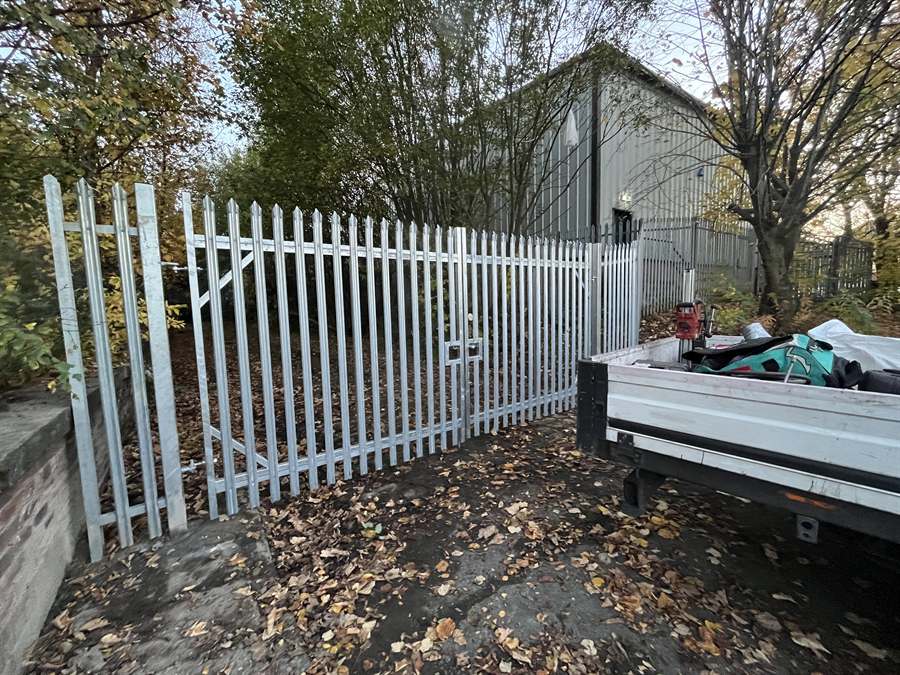 Galvanised palisade gates at the rear entrance of a factory