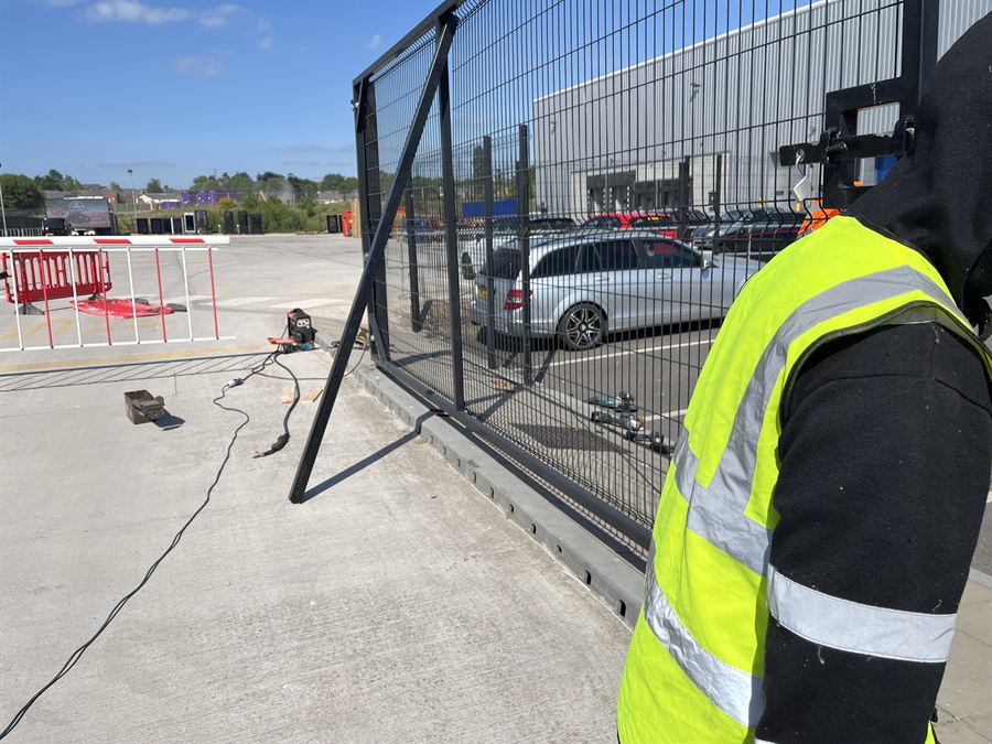 Installer hanging a 6m wide mesh gate leaf at a commercial car park