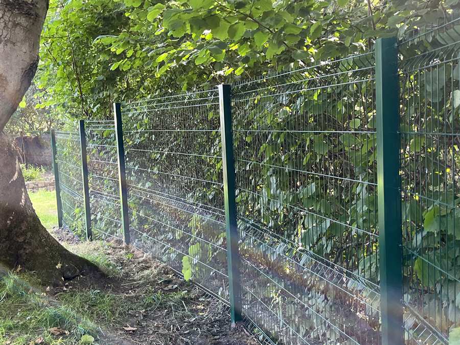 V mesh boundary fencing installed through overgrown nursing home grounds