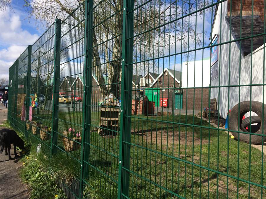 Green welded mesh fencing installed to a commercial yard
